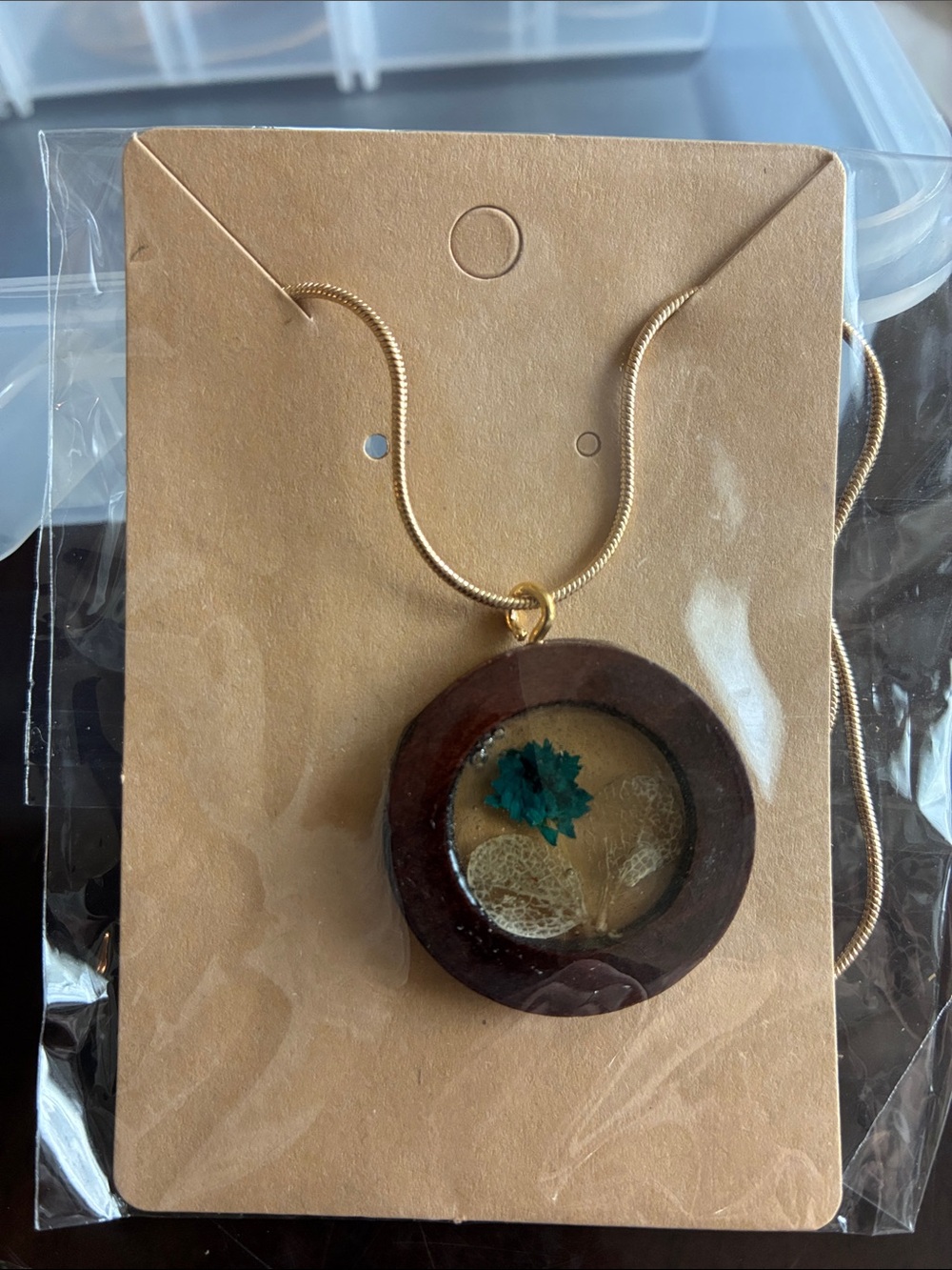 Gold-Trim Brown Round Pendant Necklace with Teal Flower
